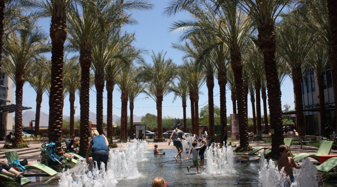 Children playing at the Scottsdale Quarter splash pad in Scottsdale, Arizona, highlighting the outdoor lifestyle that attracts families relocating from Chicago.