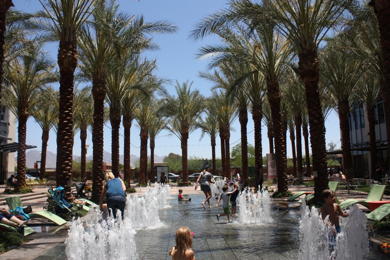 Children playing at the Scottsdale Quarter splash pad in Scottsdale, Arizona, highlighting the outdoor lifestyle that attracts families relocating from Chicago.